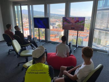 A group of people sitting on bean bags in front of a window